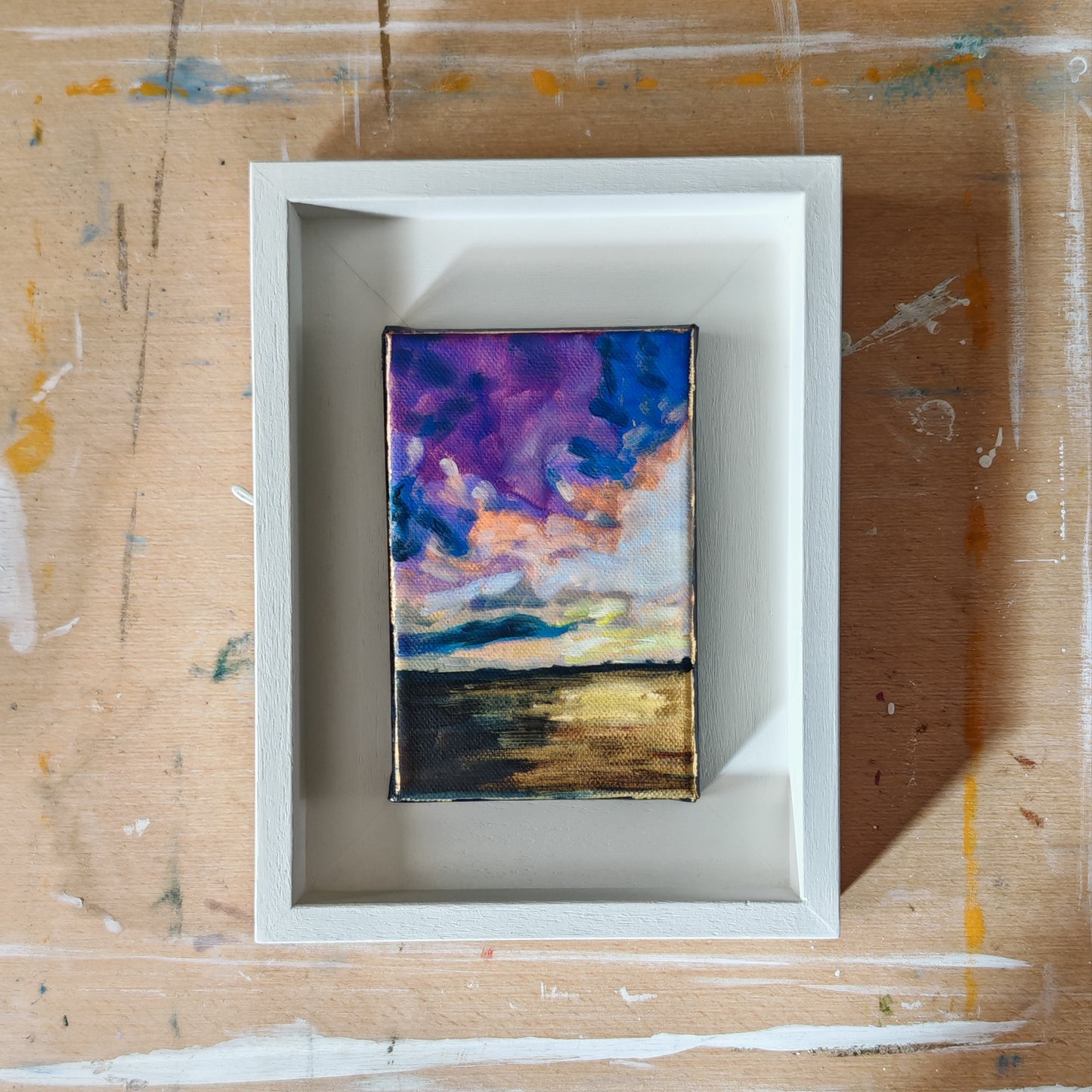 Framed abstract painting on a textured surface