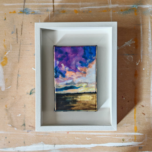 Framed abstract painting on a textured surface